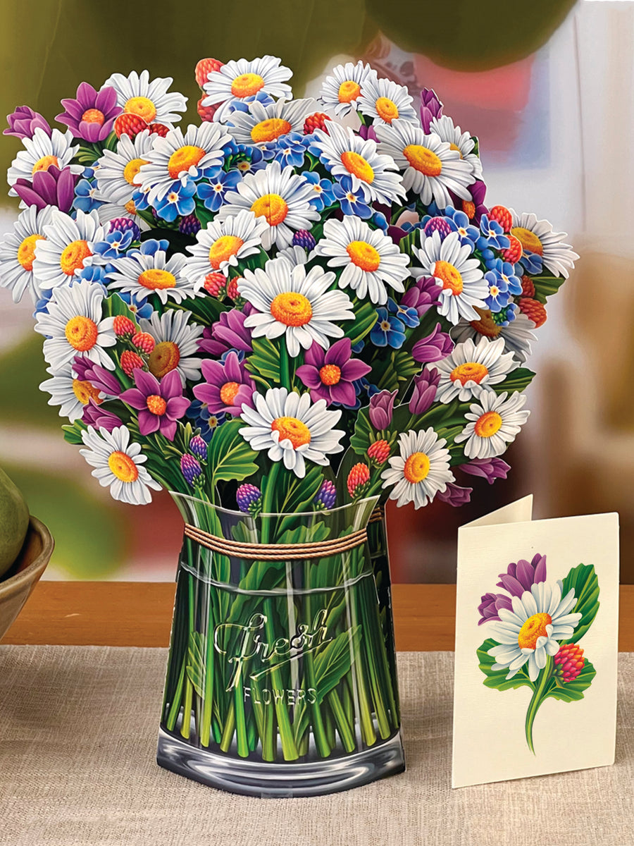 Field of Daisies paper bouquet set on a table with its enclosure card.