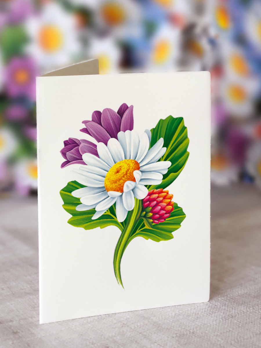 close-up of enclosure card with a white and a purple daisy printed on it.