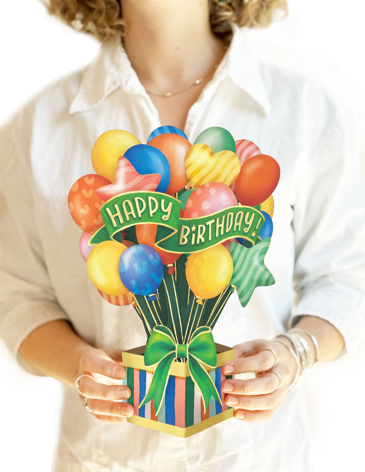 a person holding the classic birthday balloons pop up card