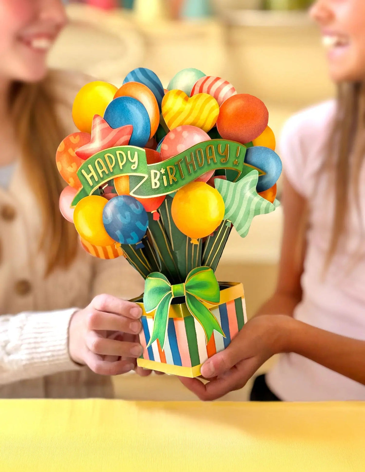 classic birthday balloons pop-up card being gifted to someone