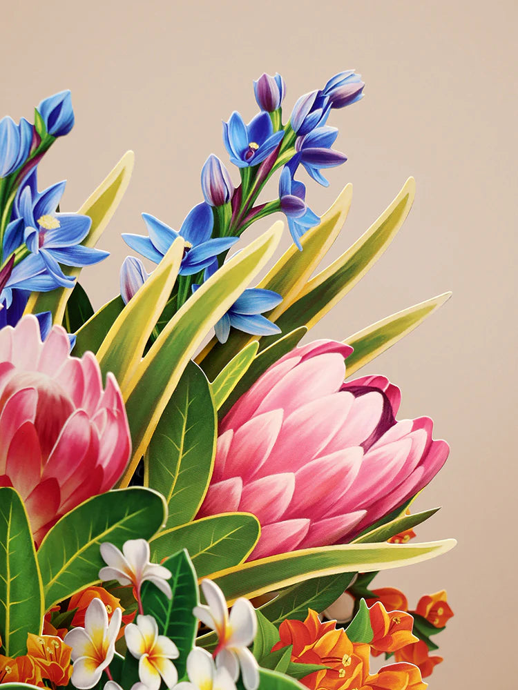 close-up of pink and blue flowers in Tropical Paradise Pop-Up Bouquet