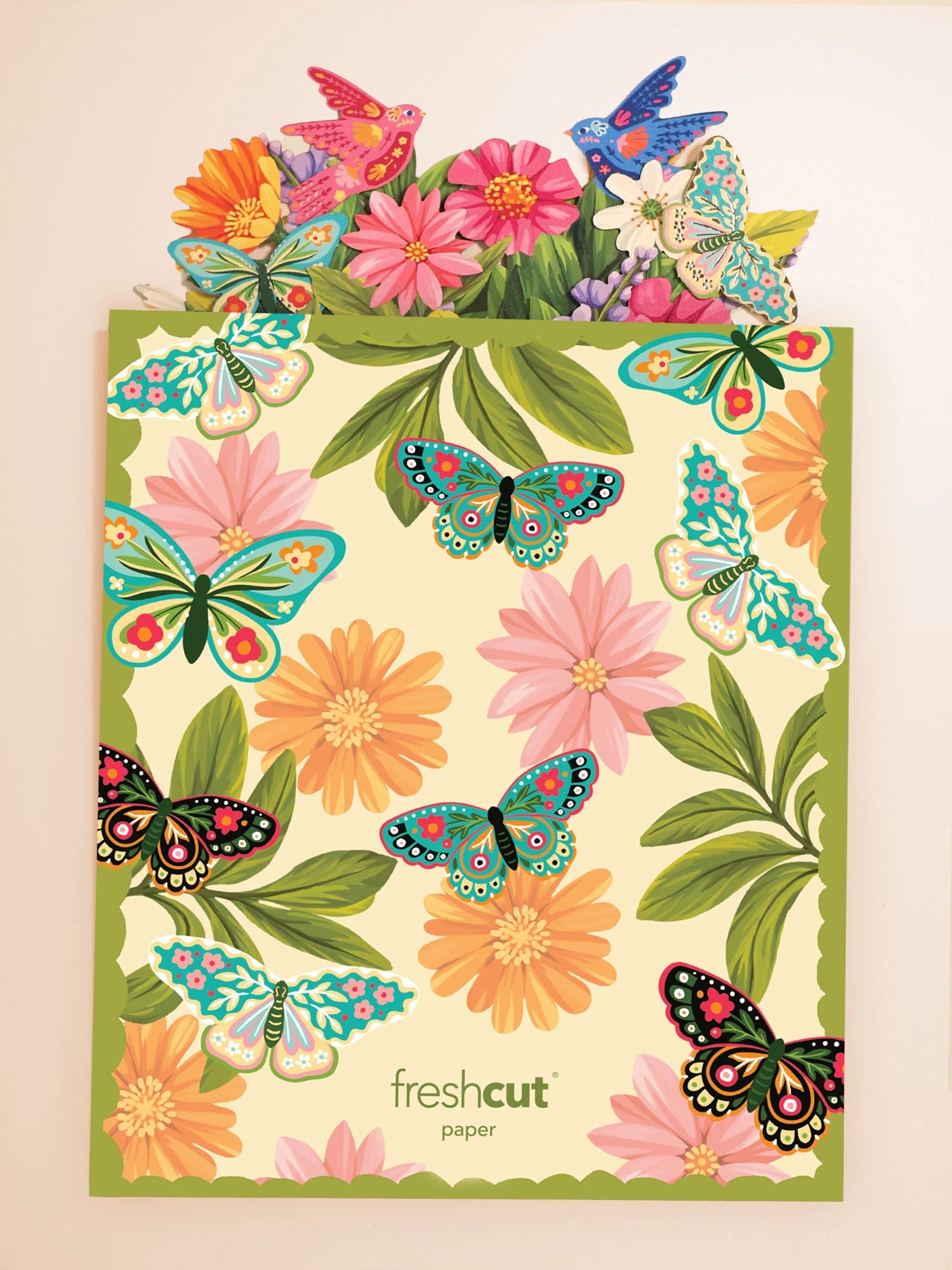 Enchanted Garden Pop-Up Bouquet coming out of its colorful envelope