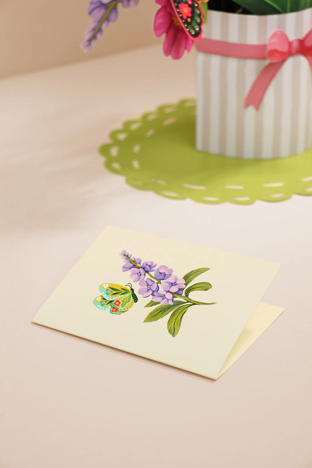 enclosure card included with the Enchanted Garden Pop-Up Bouquet, has a purple flower and yellow butterfly on it
