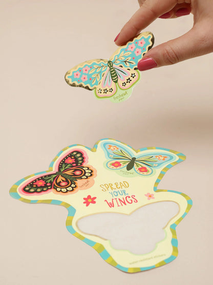 hand holding colorful butterfly sticker