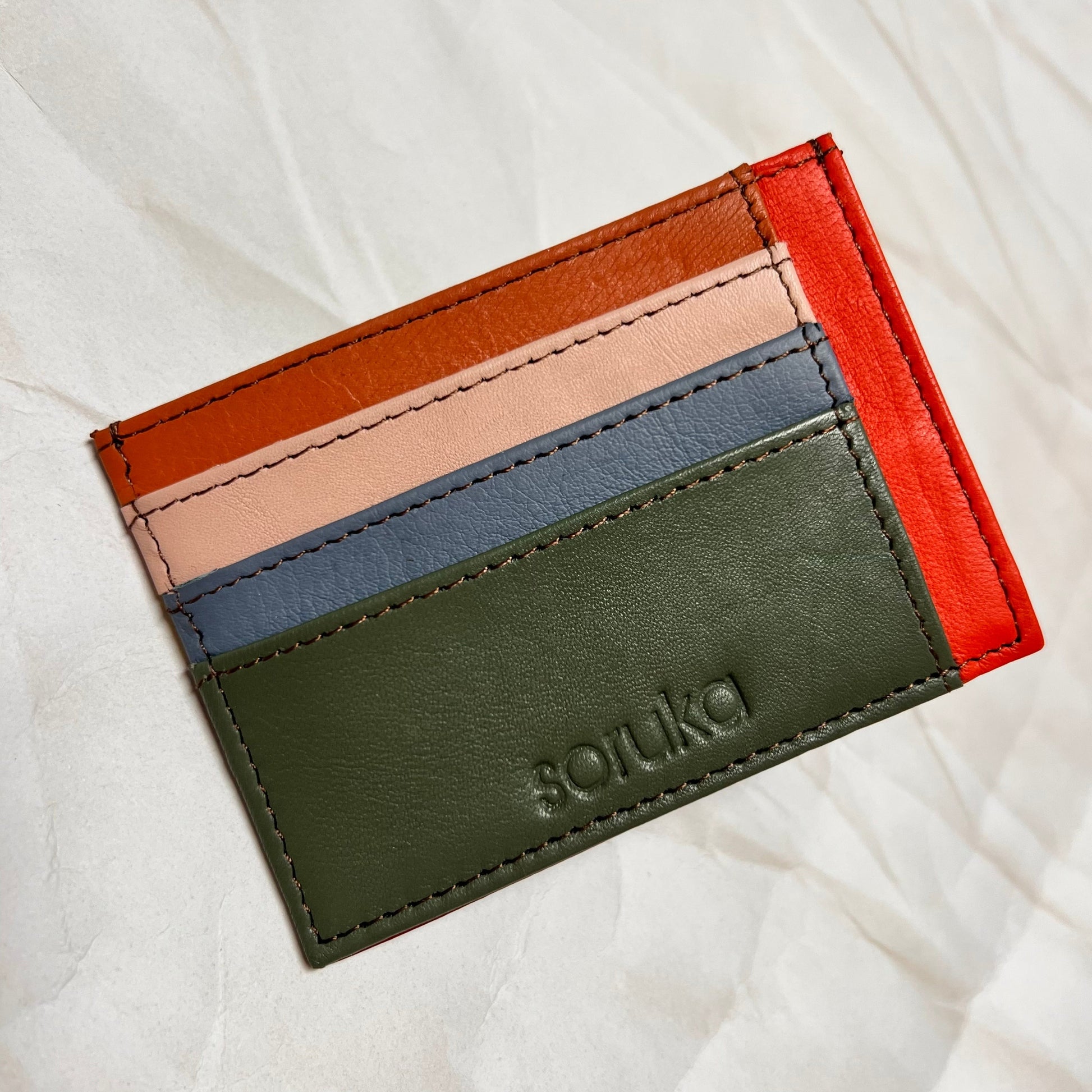 sage polly wallet with colorful card slots.