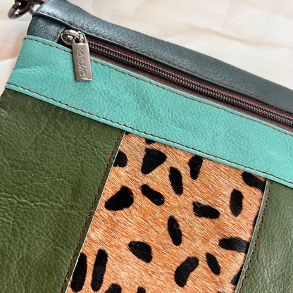 close-up of green and animal print greta bag.