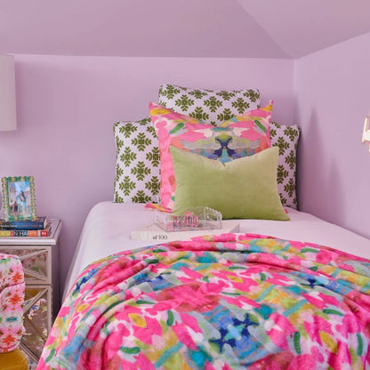 Pink Paradise Fleece Blanket draped over a bed