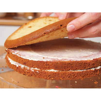 hands layering slices of cake