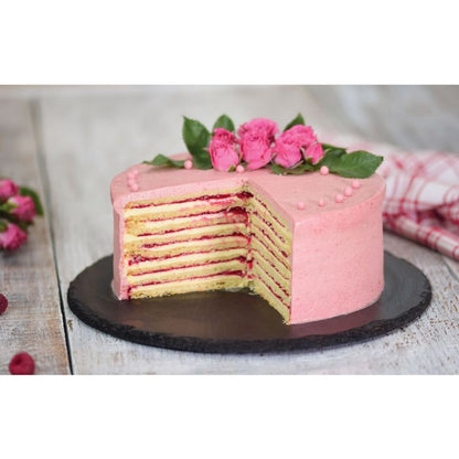 strawberry layer cake on a black marble plate with roses on top