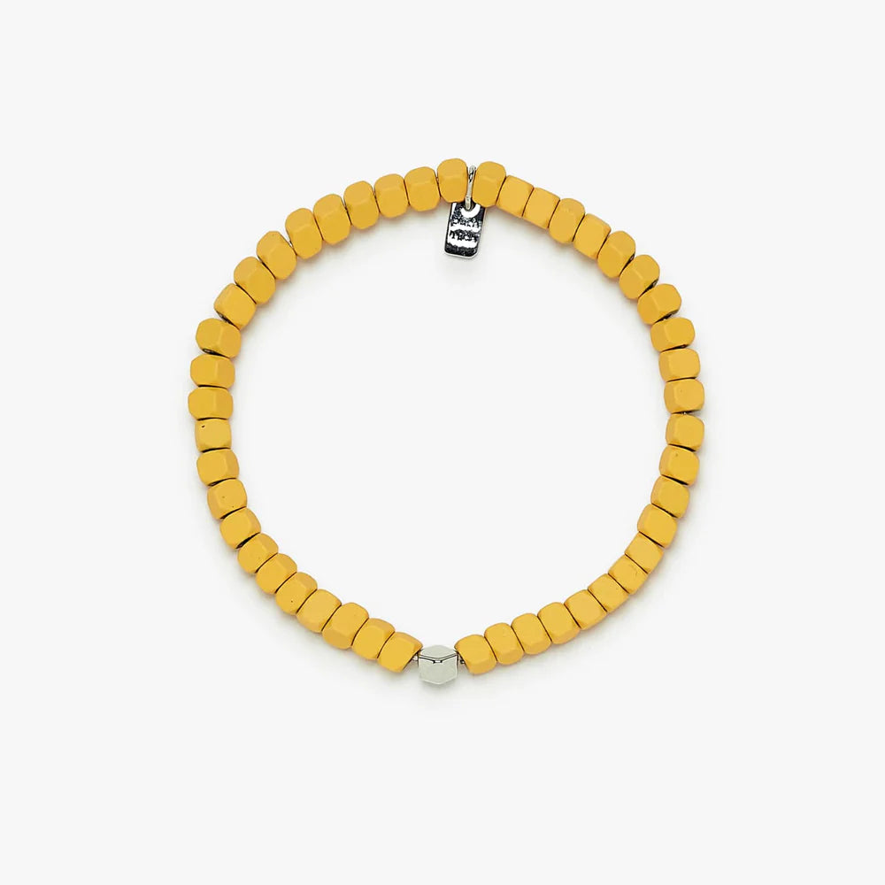 yellow beaded bracelet with one silver bead and a Pura Vida tag charm