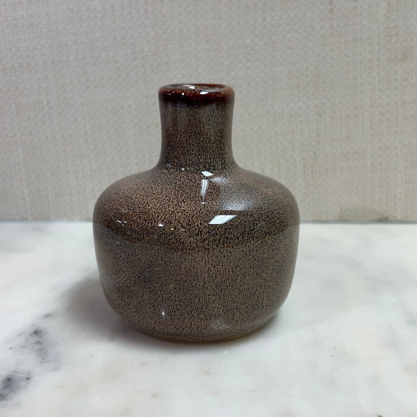 short brown vase with slim neck.