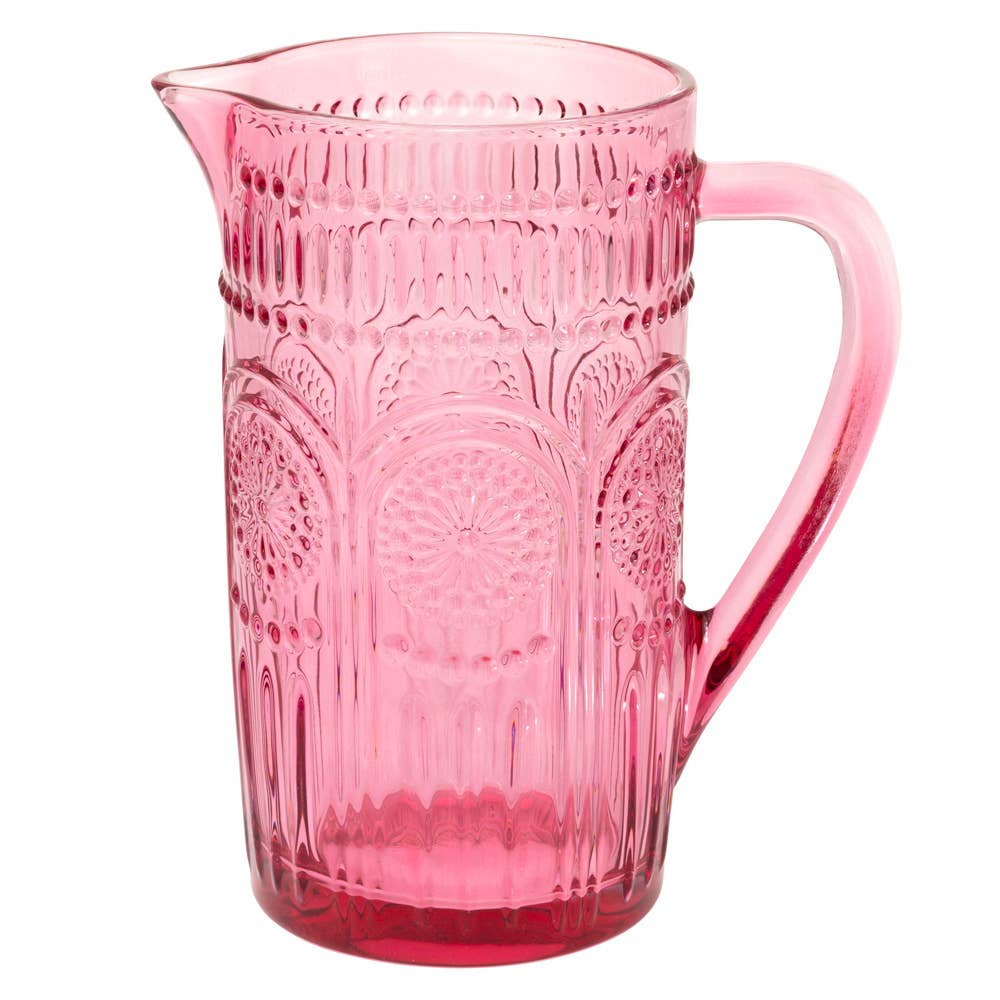 Pink Glass Pitcher with embossed designs shown on a white background