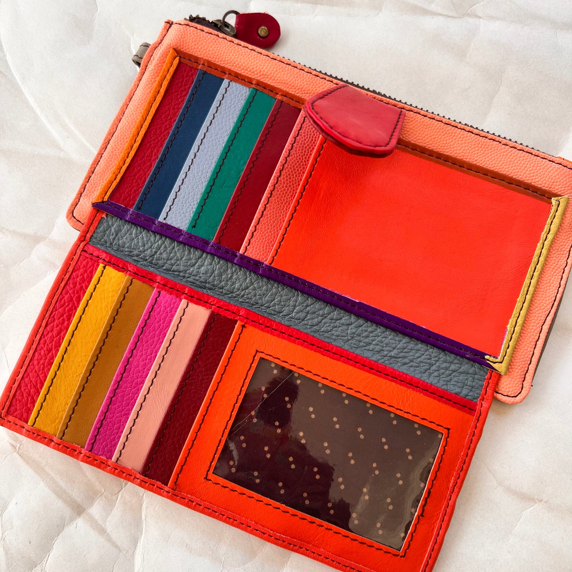 interior view of kimber wallet showing colorful card slots, pockets, and clear spot for ID.