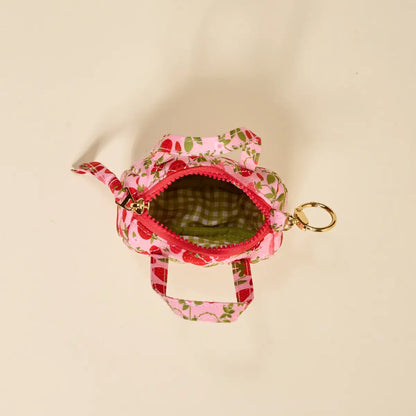 interior view of tiny duffle bag showing green gingham lining