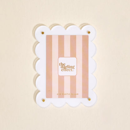 Scalloped white magnetic frame on a white background.