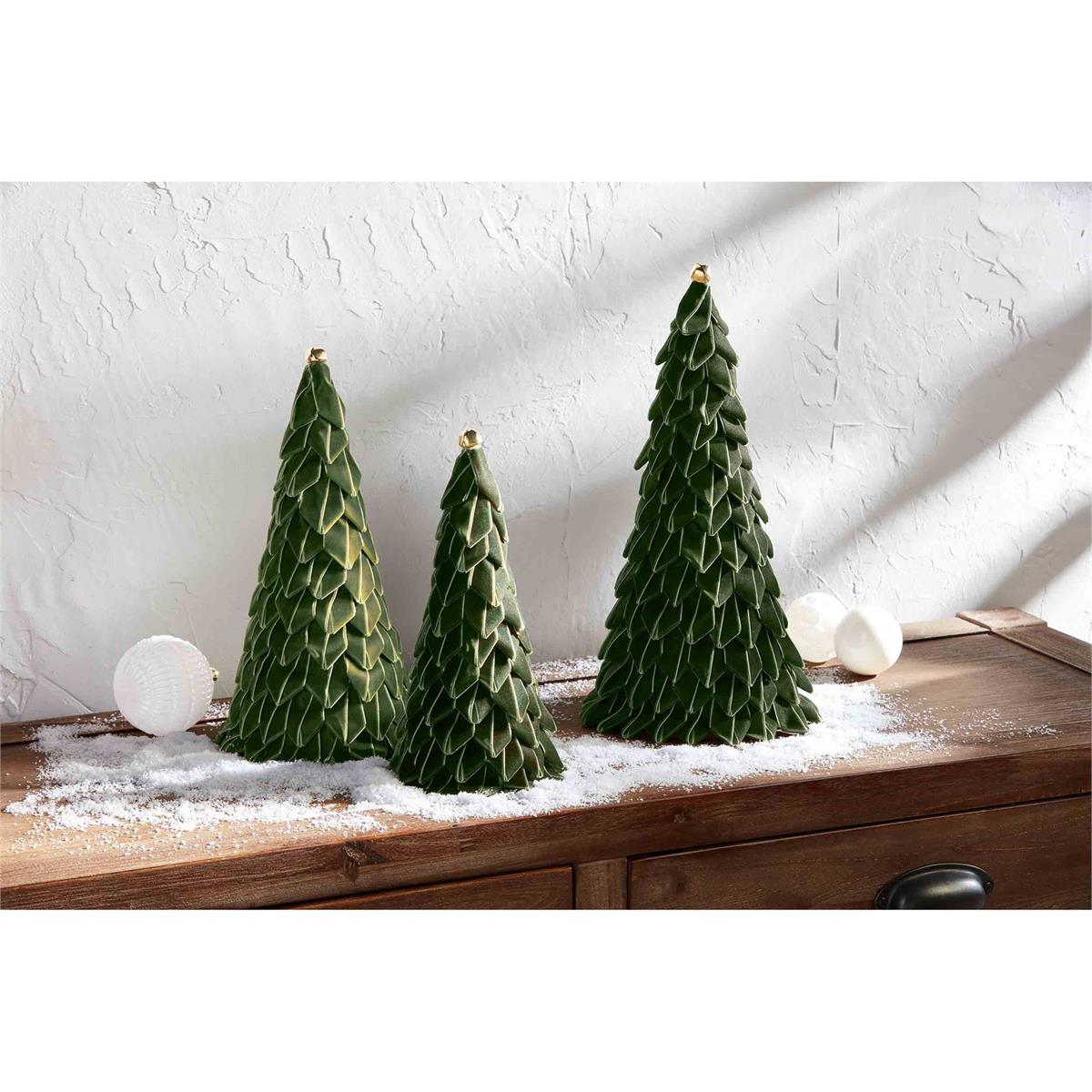 all three sizes of ribbon trees displayed on a narrow hall table surround by fake snow