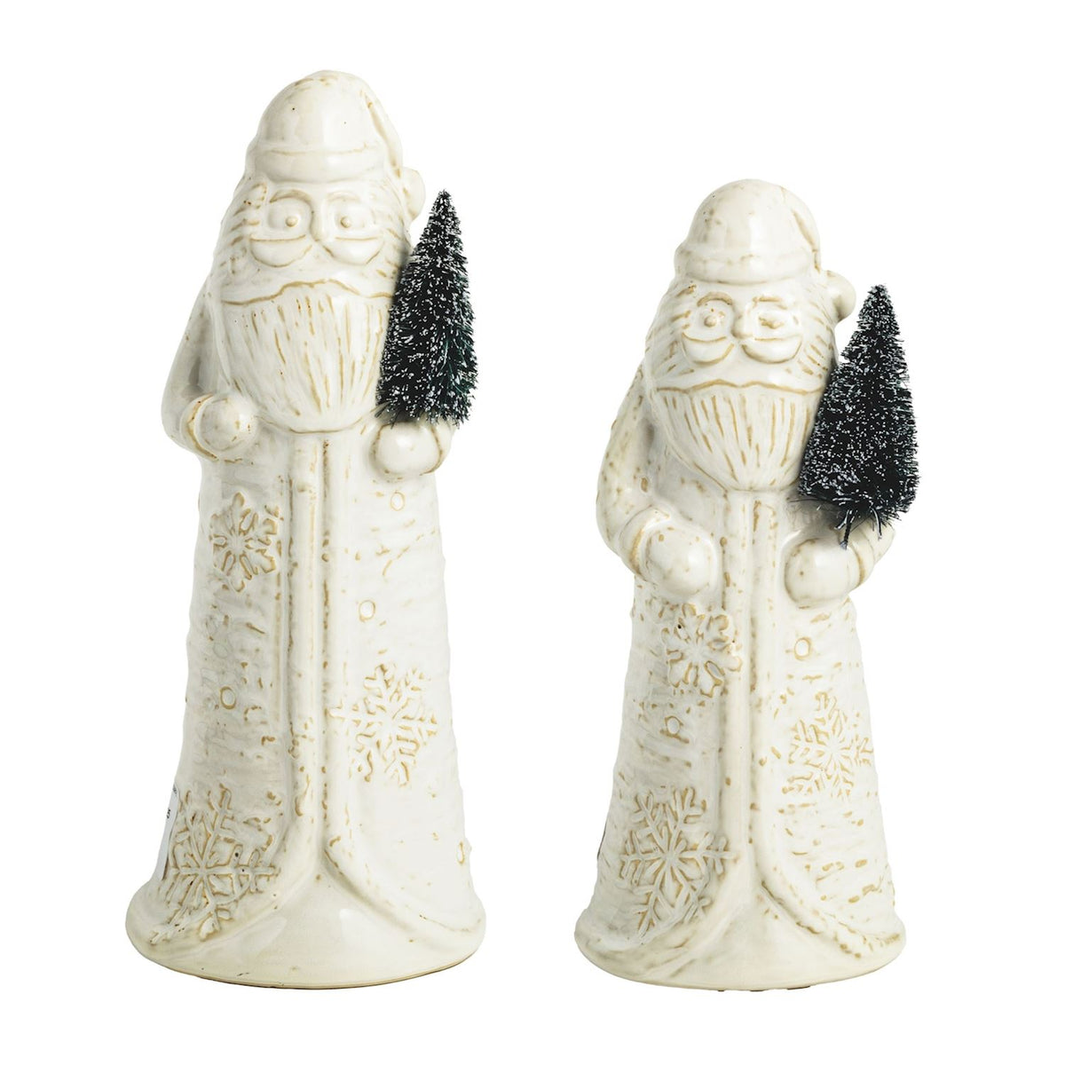 Two white ceramic figures of Santa Claus holding Christmas trees on a white background