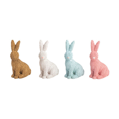 4 rattan bunny figurines, brown, white, blue, and pink in a row on a white background