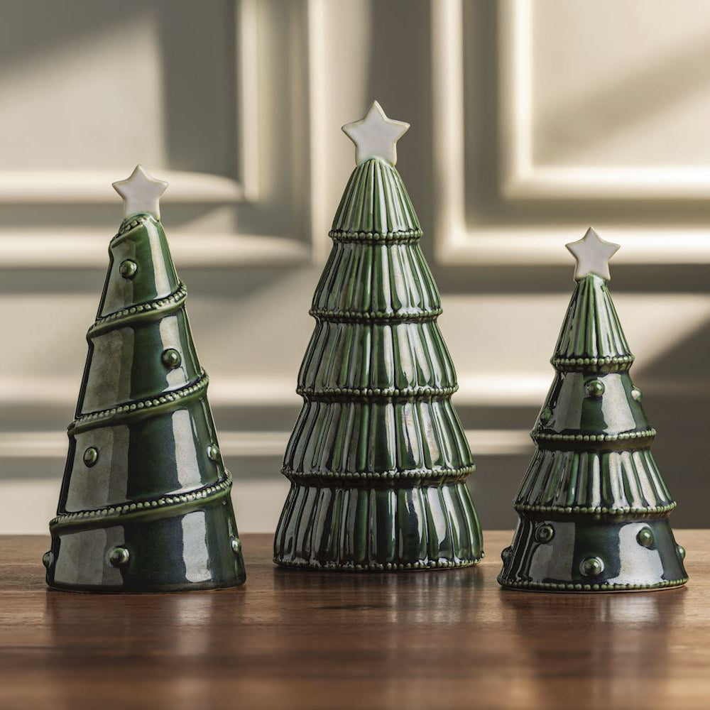 3 reactive green trees in a row on a on a wooden table