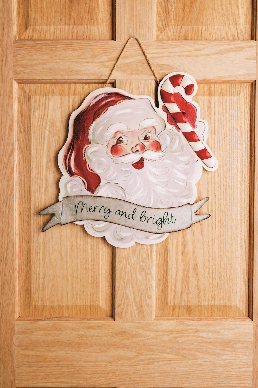 Vintage Santa Door Hanger hanging on a door