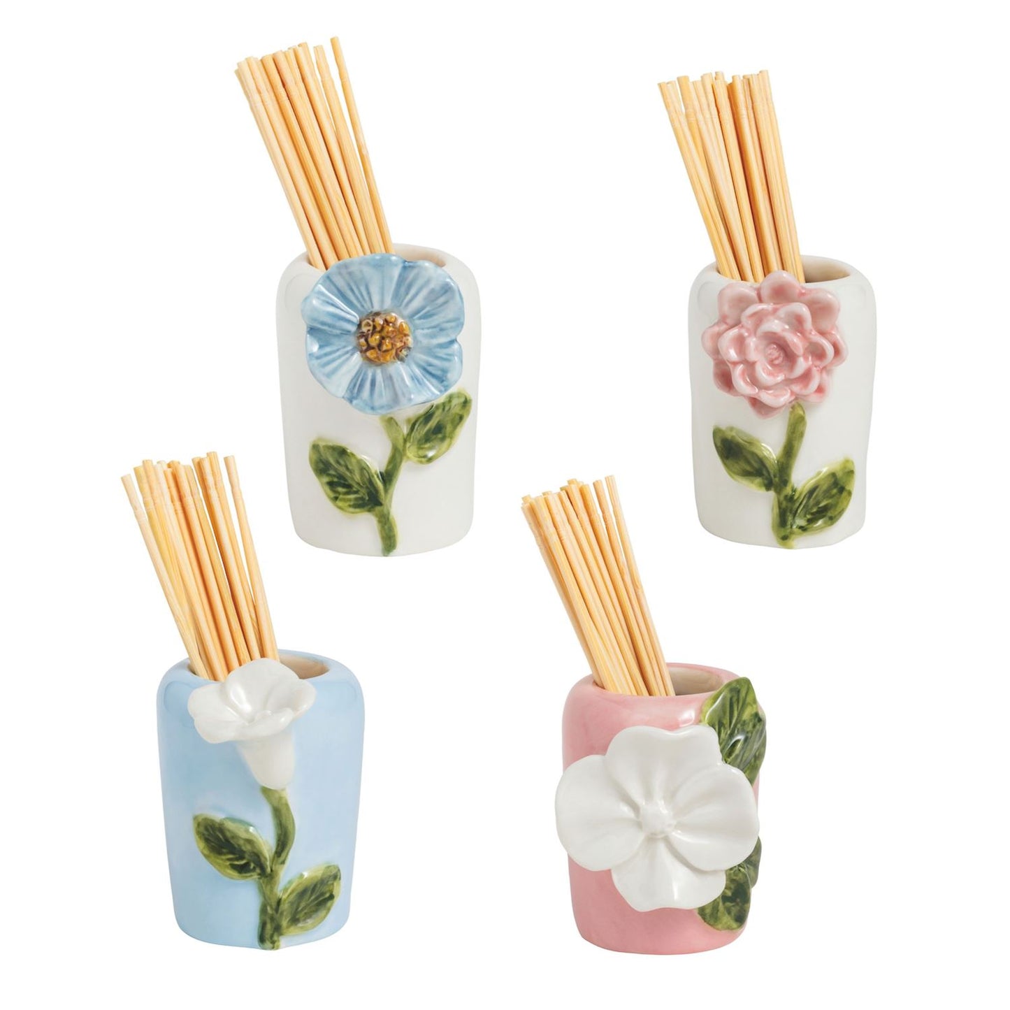 Four floral-themed ceramic vessels with wooden toothpicks in them on a white background