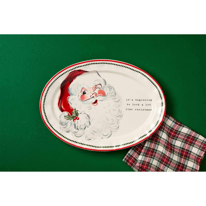 santa platter on a green background with a plaid dish towel.