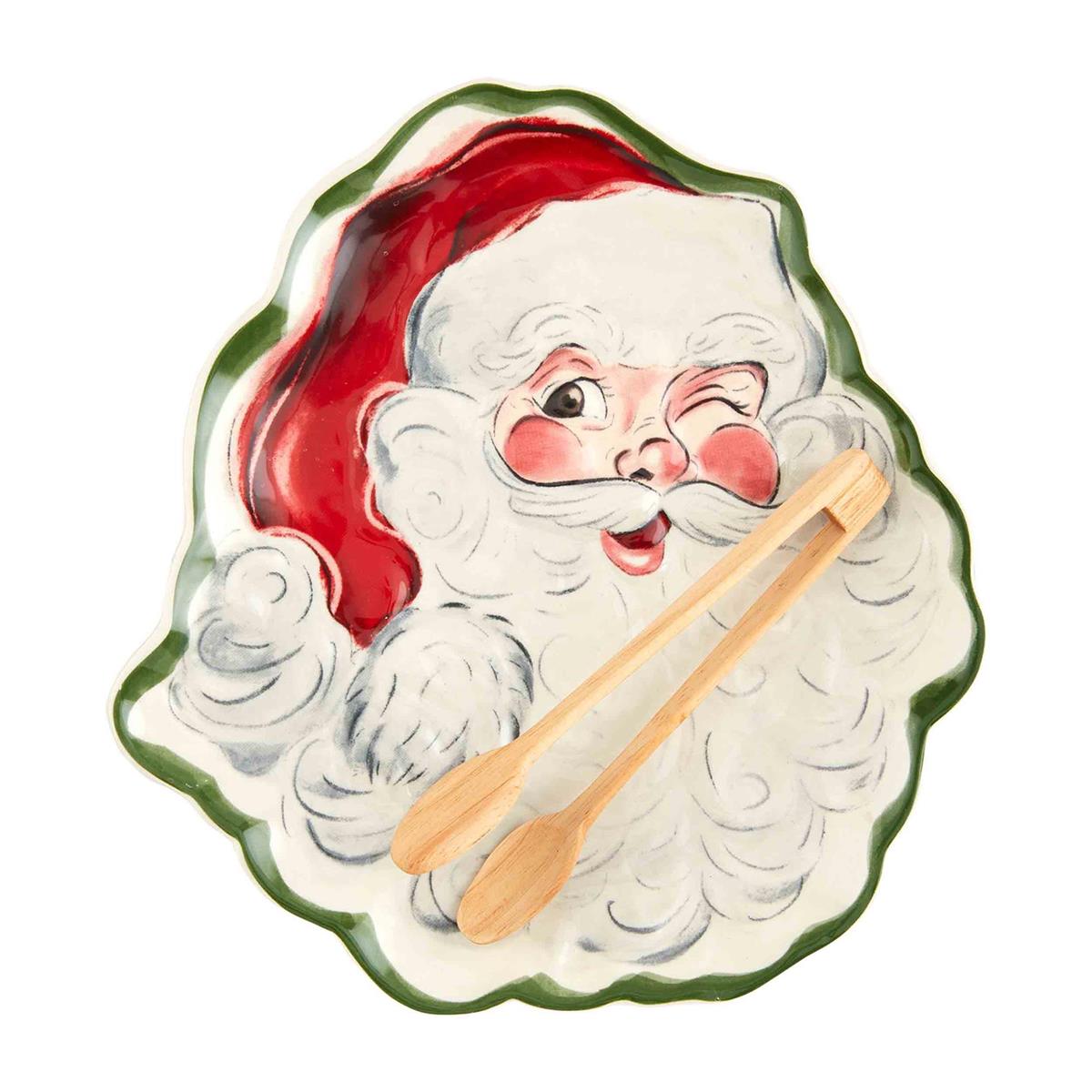 vintage santa platter with wooden tongs on it set on a white background.