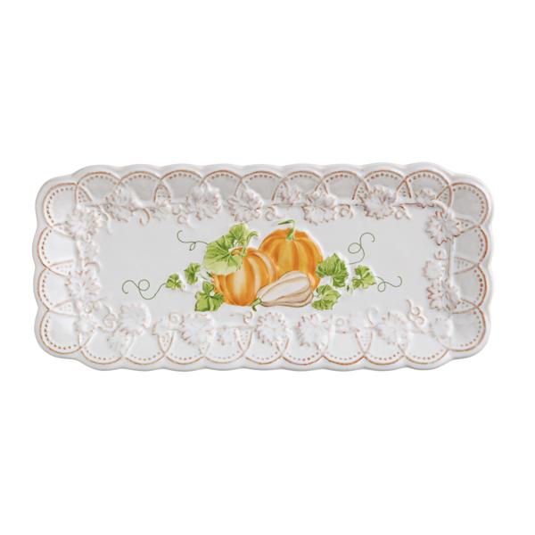 Decorative plate with orange pumpkins and lace design on a white background