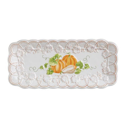 Decorative plate with orange pumpkins and lace design on a white background