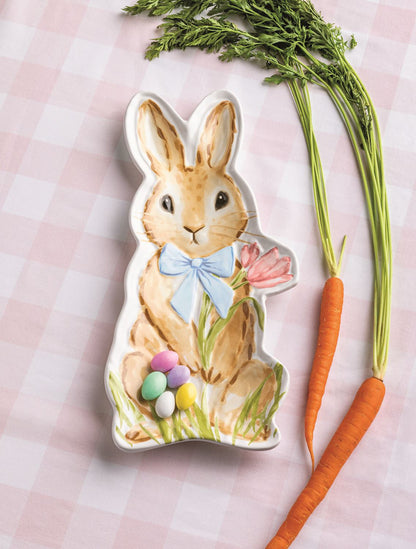 small bunny platter set on a pink gingham cloth with carrots next to it
