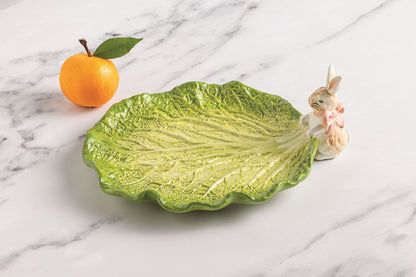 bunny cabbage planter set on a marble surface with and orange