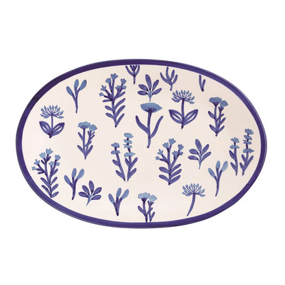 Oval platter with blue floral pattern and blue rim shown on a white background