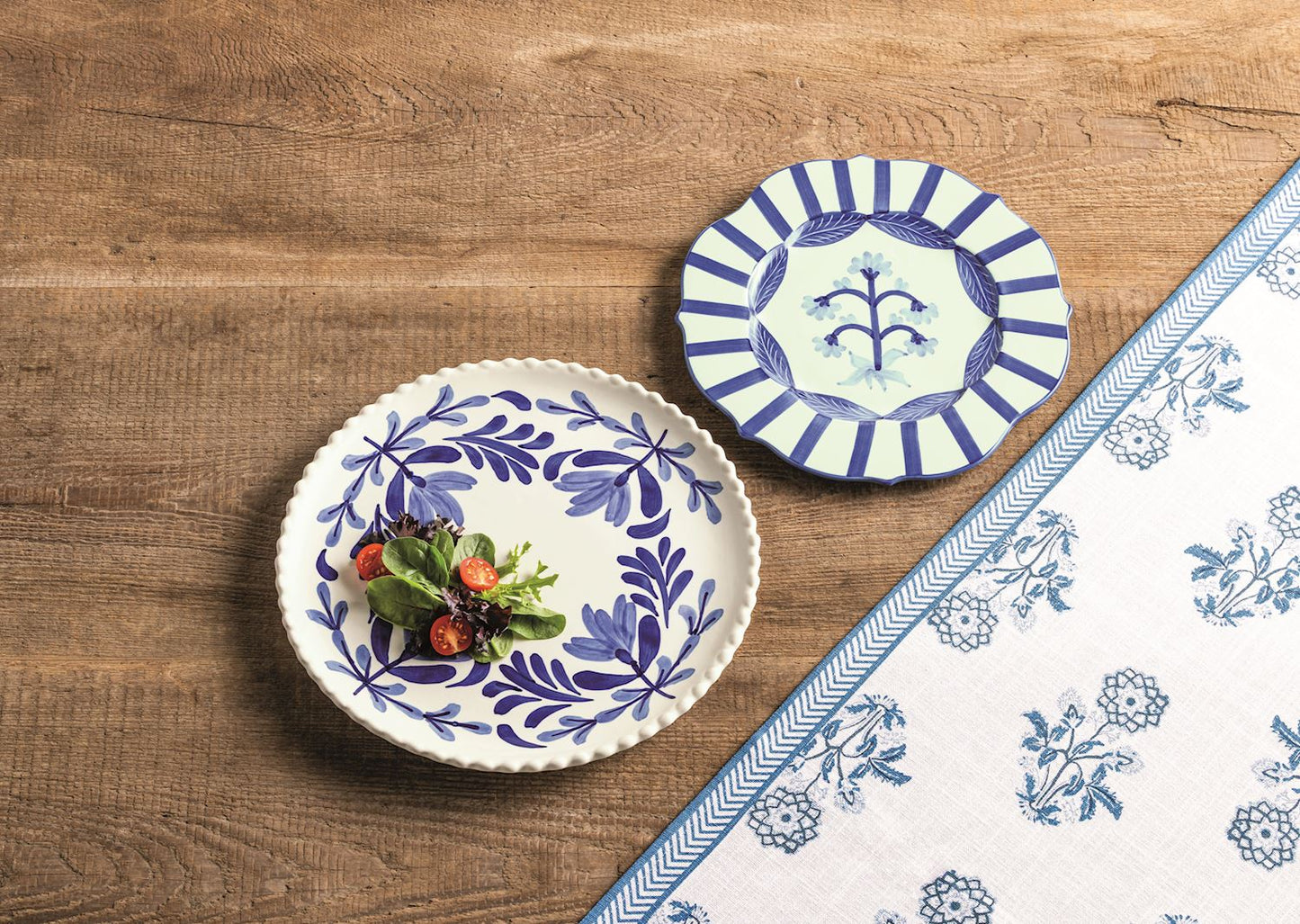 Two decorative plates with blue floral patterns on a wooden surface.