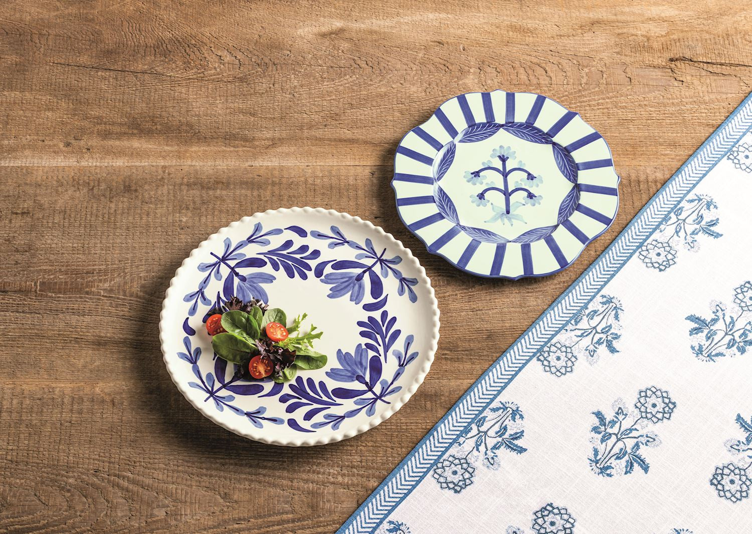 Two decorative plates with blue floral patterns on a wooden surface.