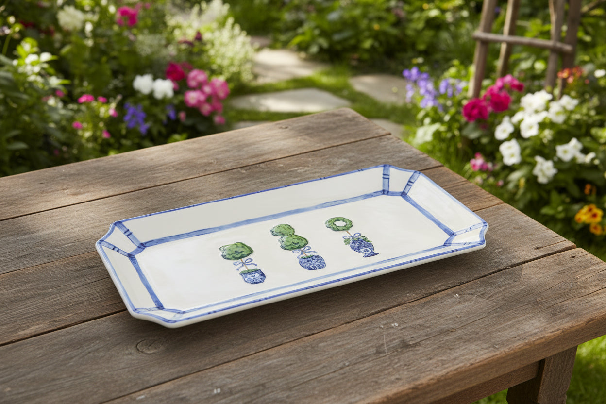 white rectangle tray with 3 topiary on them