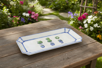 white rectangle tray with 3 topiary on them