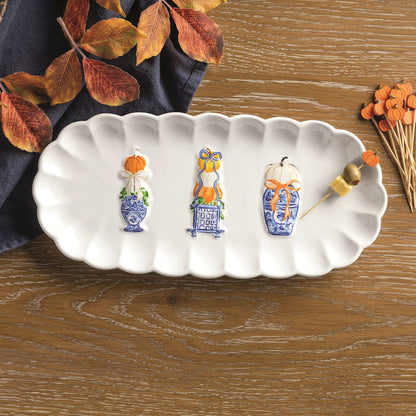 Pumpkin Topiary Tray on a wood table with a cheese and olive on toothpick on it