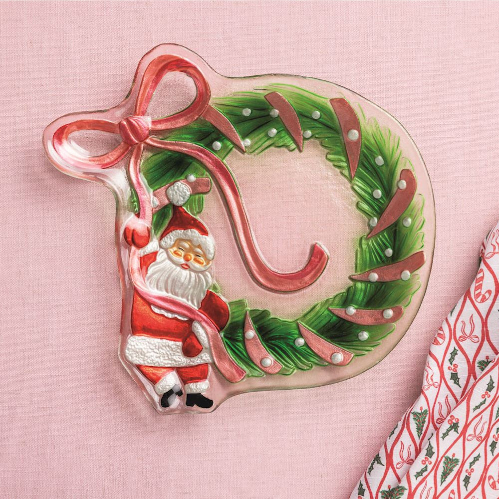 Glass Santa Bow Wreath Platter shown on a pale pink background