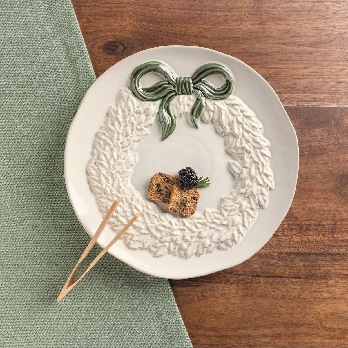 white wreath cookie plate set on a brown wood table