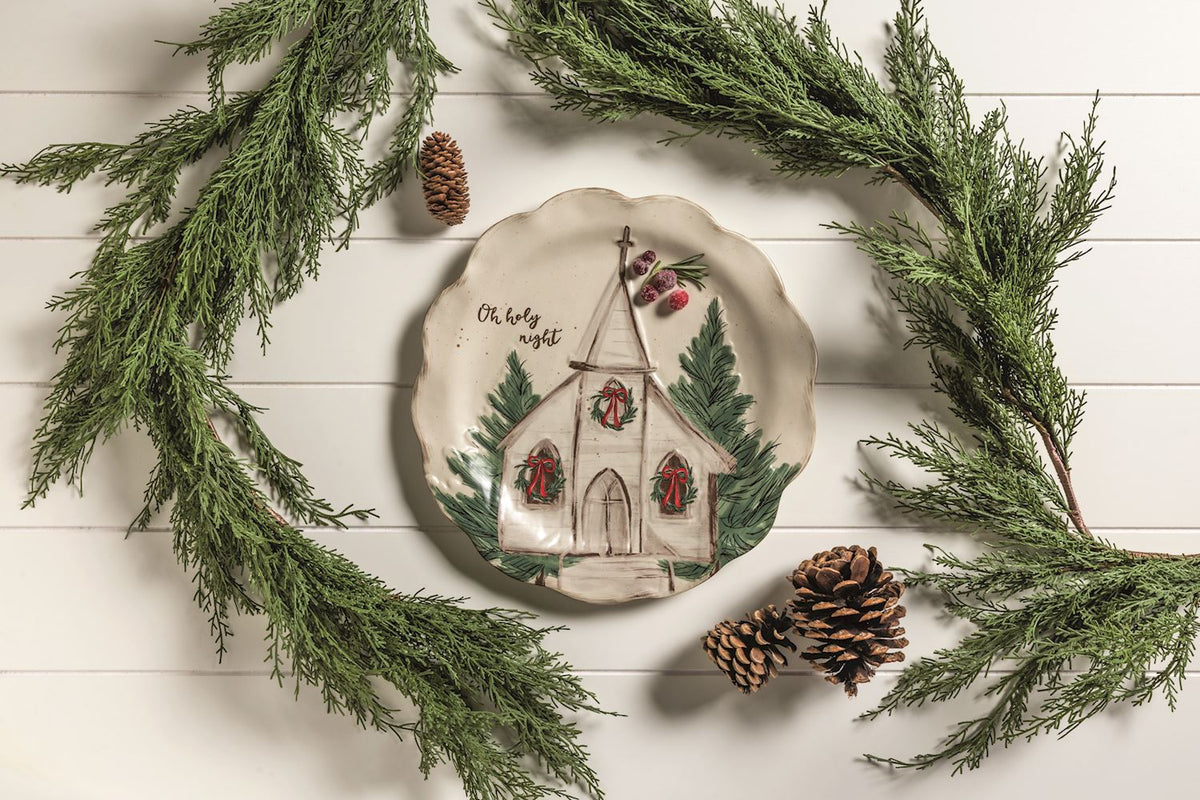 nativity church platter on a white background with evergreen garland around it