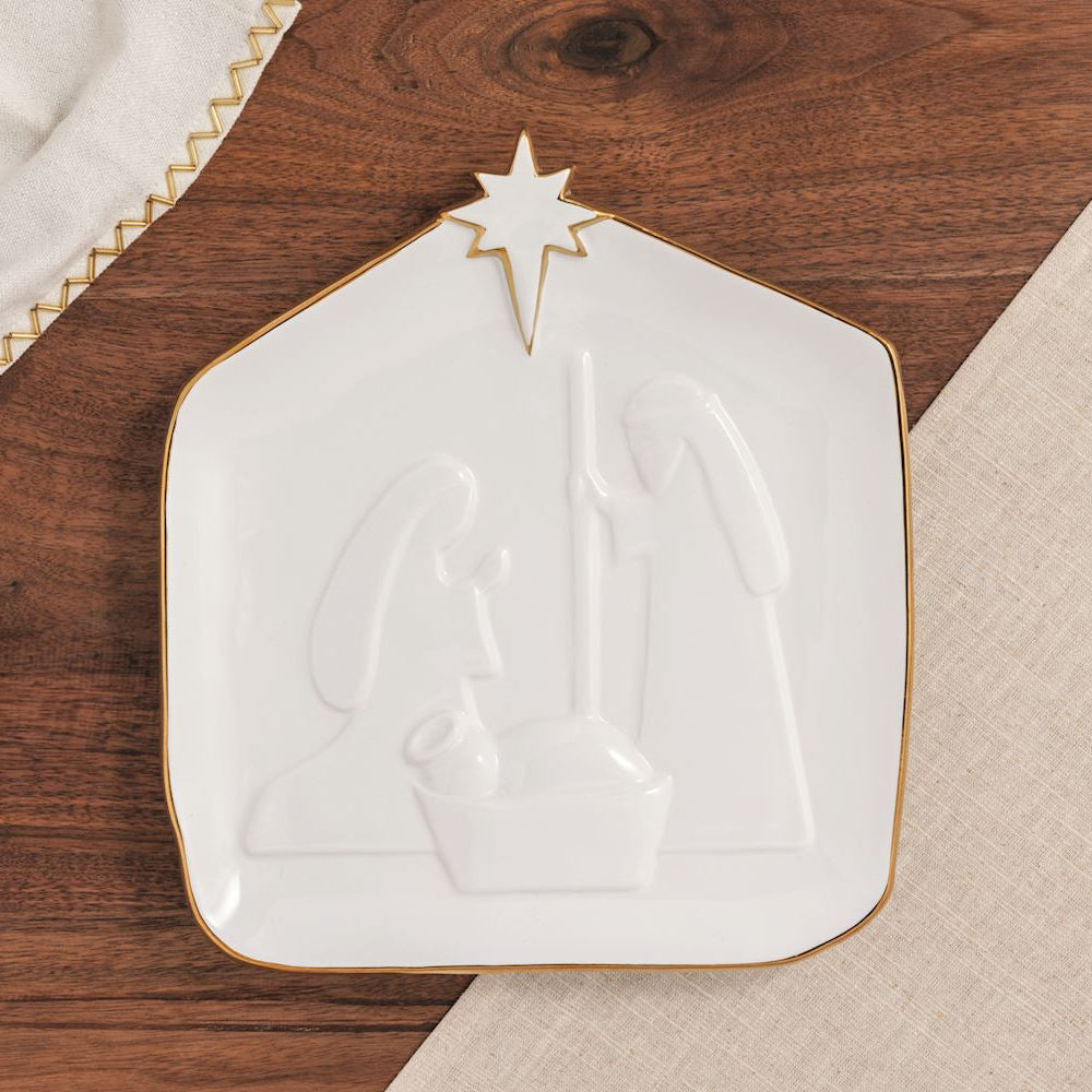 nativity platter on a wooden surface with table linens