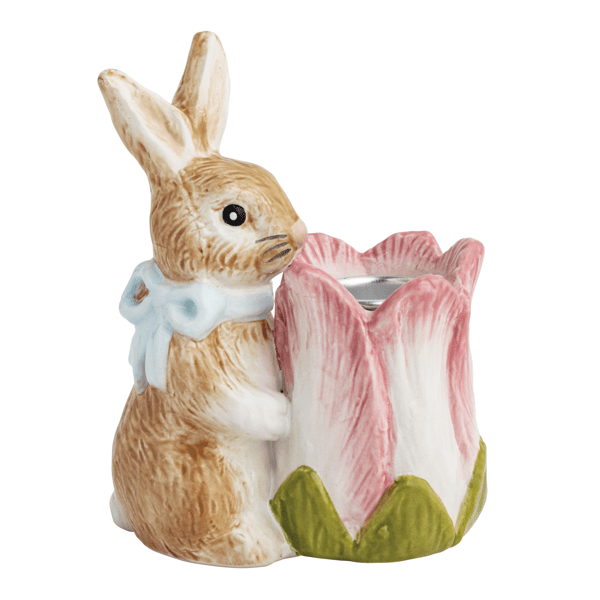 Ceramic rabbit holding a pink tulip taper holder on a white background