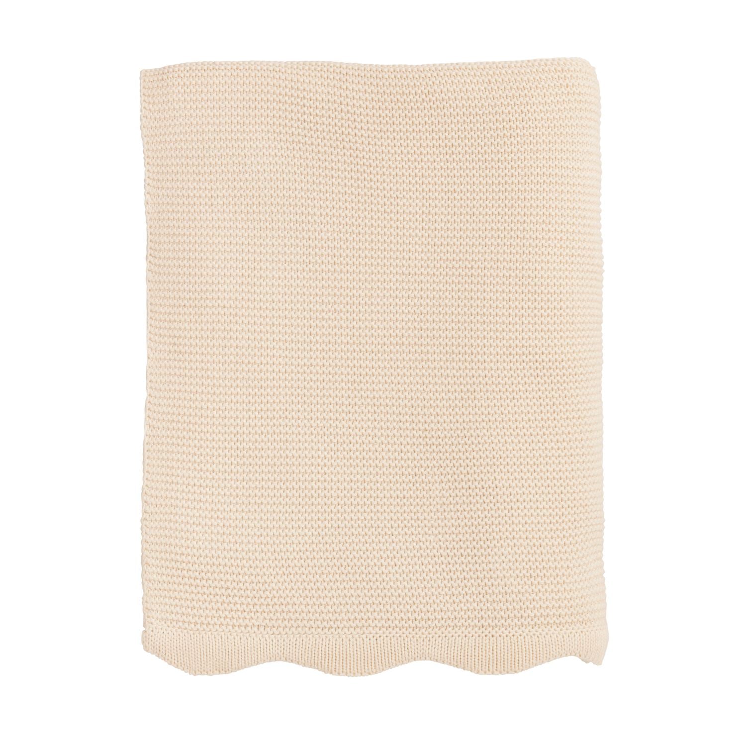 cream colored knitted blanket on a white background