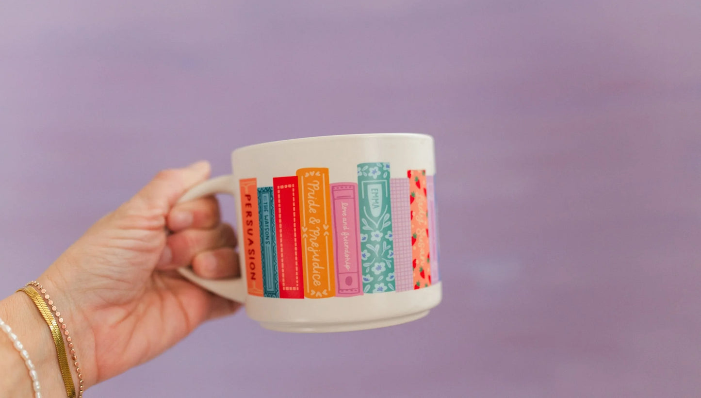 hand holding Jane Austen Books Ceramic Mug in front of lavender background