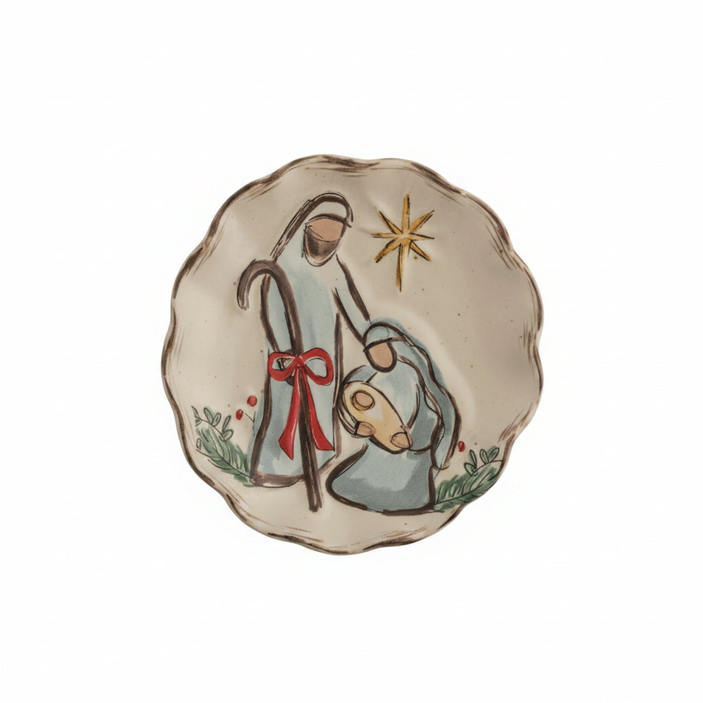 A ceramic Christmas small plate with a hand-painted scene of Mary, Joseph, and baby Jesus shown on a white background.