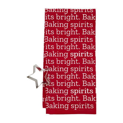 red towel with "baking spirits bright" printed on it and a star cookie cutter set next to it.