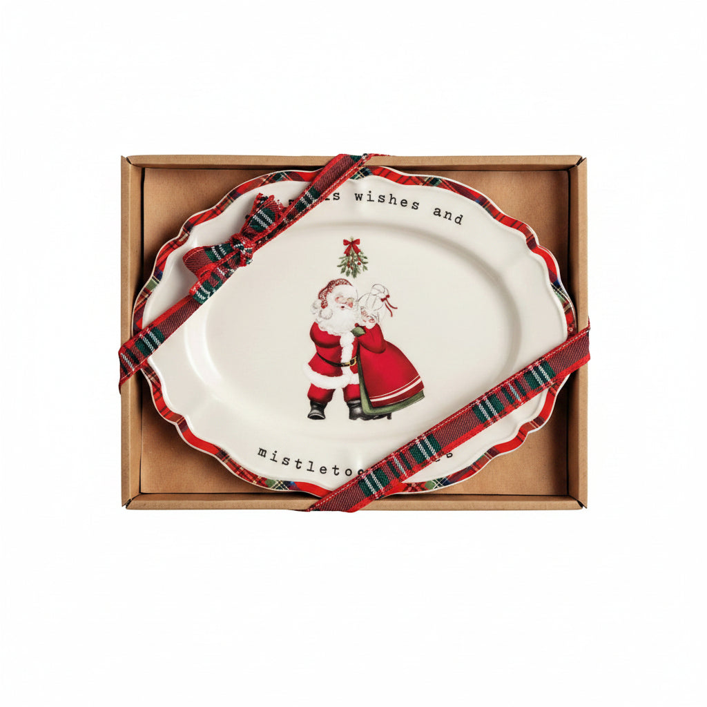 plate with design of mr and mrs claus coming standing under mistle toe shown in a box with tartan ribbon on it