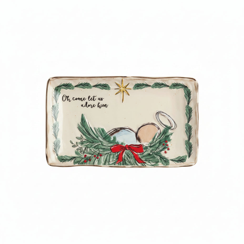 ceramic tray with evergreen boarder, baby jesus laying in an evergreen manger, and ' oh come let us adore him' in script on top left