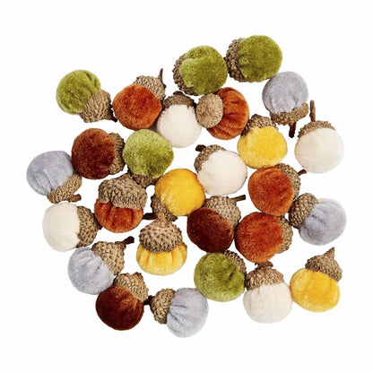 assorted velvet acorns scattered on a white background.