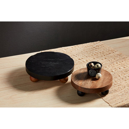 2 sizes of wooden risers on a table, small riser has a bowl of eggs on it.